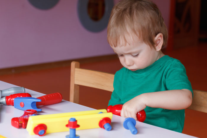 Little boy, the child plays with blocks and toys